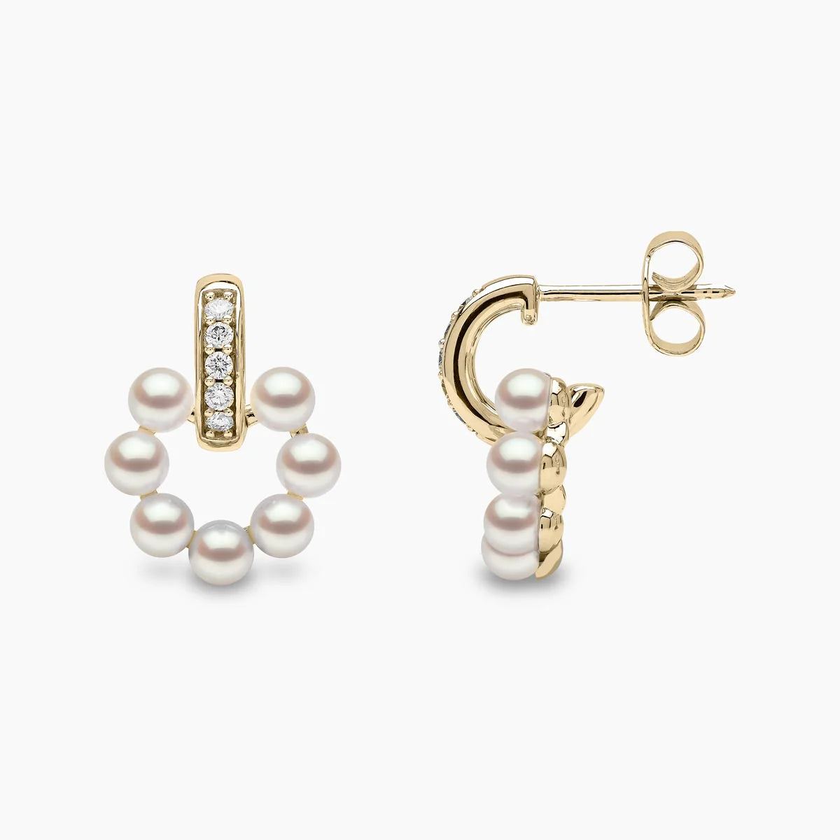 Yellow gold pearl and diamond stud earrings on grey background, front and side angle view
