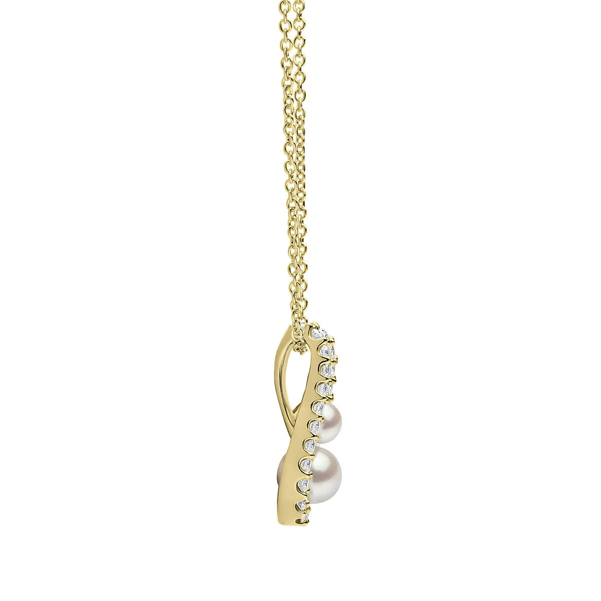 Yellow gold pearl and diamond pendant necklace on grey background, side view